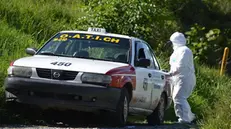 epa11482271 A police forensics officer works at the scene where lifeless bodies were found inside a transport vehicle in Chilpancingo, Guerrero, Mexico, 16 July 2024. The bodies of three individuals, two men and one woman were discovered on 16 July morning in the trunk of a public service car near the highway leading to the tourist destination of Acapulco, in the southern Mexican state of Guerrero, amid a wave of violence gripping the region. EPA/Jose Luis de la Cruz