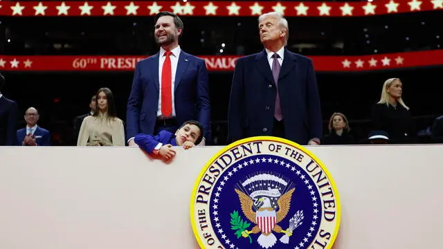 epa11840624 U.S. Vice President J.D. Vance (L) and U.S. President Donald Trump (R) look on during an indoor inauguration parade at the Capital One Arena in Washington, DC, USA, 20 January 2025. Trump was sworn in for a second term as president of the United States on 20 January. The presidential inauguration was held indoors due to extreme cold temperatures in DC. EPA/ANNA MONEYMAKER / POOL