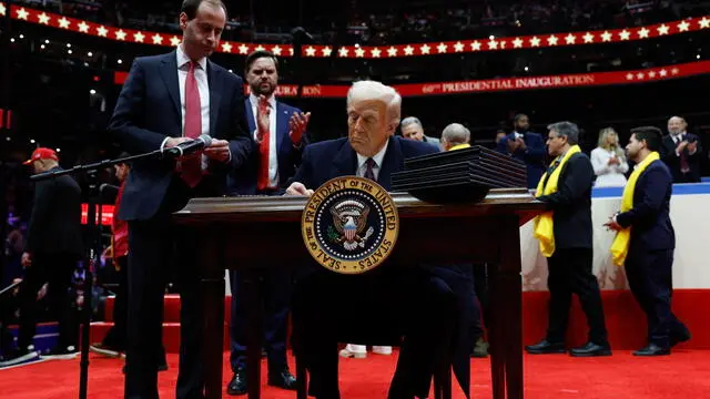 epa11840719 U.S. President Donald Trump signs executive orders during an indoor inauguration event at the Capital One Arena in Washington, DC, USA, 20 January 2025. Trump was sworn in for a second term as president of the United States on 20 January. The presidential inauguration was held indoors due to extreme cold temperatures in DC. EPA/ANNA MONEYMAKER / POOL