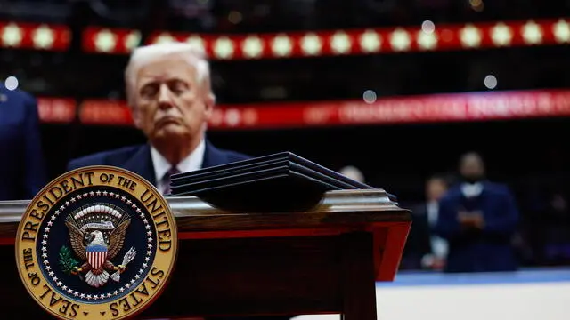 epa11840723 U.S. President Donald Trump signs executive orders during an indoor inauguration event at the Capital One Arena in Washington, DC, USA, 20 January 2025. Trump was sworn in for a second term as president of the United States on 20 January. The presidential inauguration was held indoors due to extreme cold temperatures in DC. EPA/ANNA MONEYMAKER / POOL