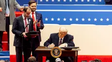 epa11840750 US President Donald Trump (C) with US Vice President JD Vance (2-L) as he signs a series of executive actions on stage during a presidential inaugural event at the Capitol One Arena in Washington, DC, USA, 20 January 2025. Earlier today Trump was sworn in for a second term as president of the United States in the rotunda of the US Capitol, though the ceremonies and events surrounding the presidential inauguration were moved indoors due to extreme cold temperatures. EPA/ALLISON DINNER