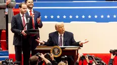 epa11840752 US President Donald Trump (C) with US Vice President JD Vance (2-L) as he signs a series of executive actions on stage during a presidential inaugural event at the Capitol One Arena in Washington, DC, USA, 20 January 2025. Earlier today Trump was sworn in for a second term as president of the United States in the rotunda of the US Capitol, though the ceremonies and events surrounding the presidential inauguration were moved indoors due to extreme cold temperatures. EPA/ALLISON DINNER