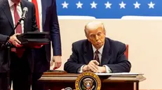 epa11840749 US President Donald Trump signs a series of executive actions on stage during a presidential inaugural event at the Capitol One Arena in Washington, DC, USA, 20 January 2025. Earlier today Trump was sworn in for a second term as president of the United States in the rotunda of the US Capitol, though the ceremonies and events surrounding the presidential inauguration were moved indoors due to extreme cold temperatures. EPA/ALLISON DINNER