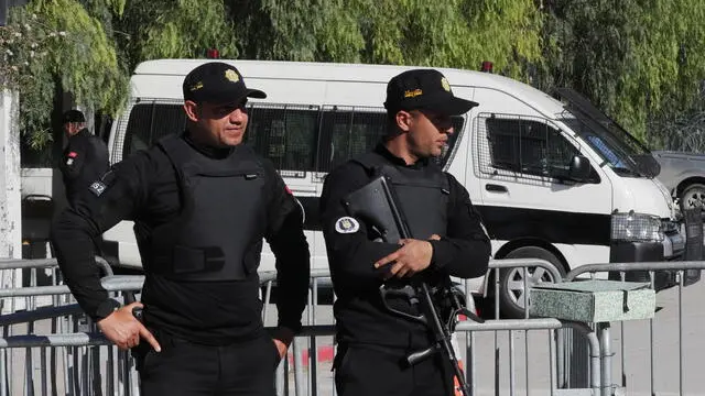 epa10520260 Police officers stand guard outside the Tunisian Parliament building as the new assembly holds its first session in Tunis, Tunisia, 13 March 2023. The Tunisian National Assembly is holding the first plenary session following the legislative elections of December 2022 and after the suspension and then the dissolution of the former assembly by President Kais Saied on 25 July 2021. EPA/MOHAMED MESSARA
