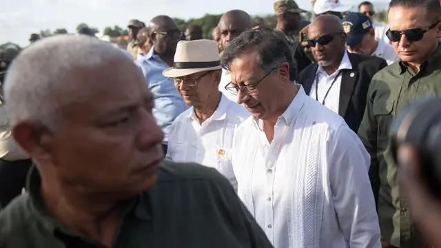 epa11846039 Colombian President Gustavo Petro (Center R) walks alongside the President of the Transitional Council (CPT), Leslie Voltaire (Center L), upon their arrival at Jacmel Airport in Jacmel, Haiti, 22 January 2025. Petro arrived in Jacmel for a brief visit to strengthen bilateral relations and cooperation. EPA/JOHNSON SABIN