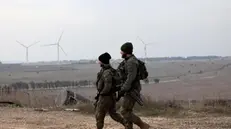 epa11761936 Israeli soldiers walk near the Quneitra crossing, on the Israeli side of the border with Syria, in the Israeli-annexed Golan Heights, 07 December 2024. Following developments in the internal conflict in Syria, Israel's military said it called up additional forces for 'defensive missions' in the Golan Heights area, adjacent to the Israel-Syria border. EPA/ATEF SAFADI