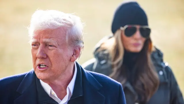 epa11849817 US President Donald Trump (L), alongside First Lady Melania Trump, speaks to reporters as he departs the White House for North Carolina, where he is expected to tour hurricane damage, followed by a visit to tour fire damage in Los Angeles, in Washington, DC, USA, 24 January 2025. Trump spoke about the upcoming Congressional vote on his nominee for Department of Defense Hegseth. EPA/JIM LO SCALZO