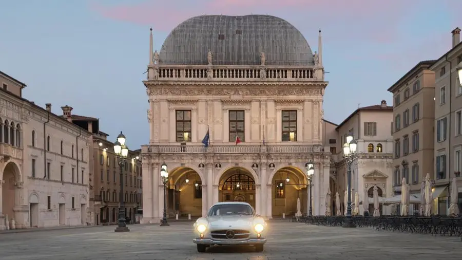 Una suggestiva immagine di un'auto storica in piazza Loggia - © www.giornaledibrescia.it