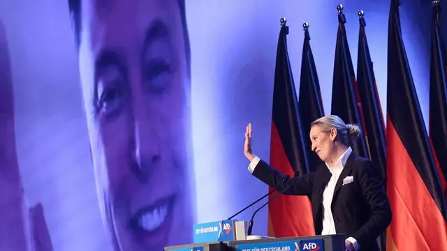 epaselect epa11852370 Alternative for Germany (AfD) party and faction co-chairwoman and top candidate for the federal election Alice Weidel talks online to Elon Musk during her speech during election campaign launch in Halle, Germany, 25 January 2025. Germany will hold early federal elections on 23 February 2025. EPA/HANNIBAL HANSCHKE