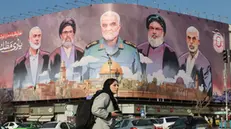 epaselect epa11841318 Iranians walk past a billboard with the pictures of late Iranian Islamic Revolutionary Guard Corps (IRGC) Quds Force commander Qasem Soleimani (C), late Hamas leaders Ismail Haniyeh (L) and Yahya Sinwar (R), and late Hezbollah leader Hasan Nasrallah (2-R), and the head of Hezbollah's executive council Hashem Safieddine (2-L), and a sentence reading in Persian 'God wrote our duty, to help the oppressed' at the Enghelab square in Tehran, Iran, 21 January 2025. Trump was sworn in as the 47th President of the United States on 20 January 2025. EPA/ABEDIN TAHERKENAREH