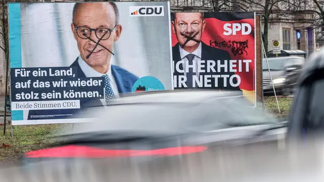 epa11847383 Damaged election campaign posters of German Chancellor Olaf Scholz (R), the Social Democratic Party's (SPD) main candidate, and the Chairman of the Christian Democratic Union (CDU) party, Friedrich Merz, the party's main candidate, are on display in Berlin, Germany, 23 January 2025. Germany will hold early federal elections on 23 February 2025. EPA/HANNIBAL HANSCHKE
