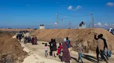 epa11856761 Palestinians displaced by Israel to the south during the war, make their way through a checkpoint as they return to their homes in northern Gaza amid a ceasefire between Israel and Hamas, near Gaza City, 27 January 2025. According to the UN, at least 1.9 million people (or nine in ten people) across the Gaza Strip are internally displaced, including people who have been repeatedly displaced. EPA/HAITHAM IMAD