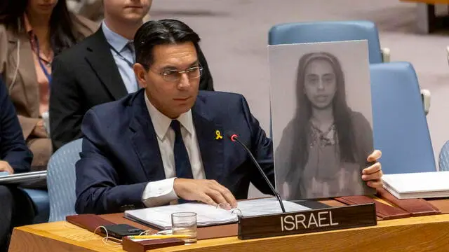 epa11585504 Israel Ambassador Danny Danon holds a poster with an image of Eden Yerushalmi, one of six Israeli hostages recently killed by Hamas, during a Security Council meeting at the United Nations Headquarters in New York, New York, USA, 04 September 2024. Israeli UN ambassador Danny Danon said on X, formerly Twitter, that the UN Security Council convenes on 04 September for the first time for an official discussion on the situation of the hostages held by Hamas in the Gaza Strip, following the recovery of the bodies of six hostages held by Hamas in the Gaza Strip on 31 August. According to a statement by the Israeli Government Press Office, 97 Israeli hostages remain in captivity in the Gaza Strip, with 33 confirmed dead. EPA/SARAH YENESEL EPA-EFE/SARAH YENESEL