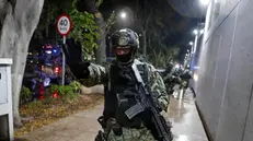 epa10990365 A soldier gestures as military forces guard the headquarters of the Specialized Prosecutor's Office for Organized Crime (Femdo) following the transfer of Nestor Isidro Garcia 'El Nini', alleged head of security of Los Chapitos criminal group, in Mexico City, Mexico, 22 November 2023. The Secretariat of Security and Citizen Protection (SSPC) of Mexico reported that the head of security of the Los Chapitos group, made up of the four sons of drug trafficker Joaquin 'El Chapo' Guzman, was arrested by agents of the Secretariat of National Defense (Sedena) in Sinaloa state capital Culiacan. EPA/Isaac Esquivel