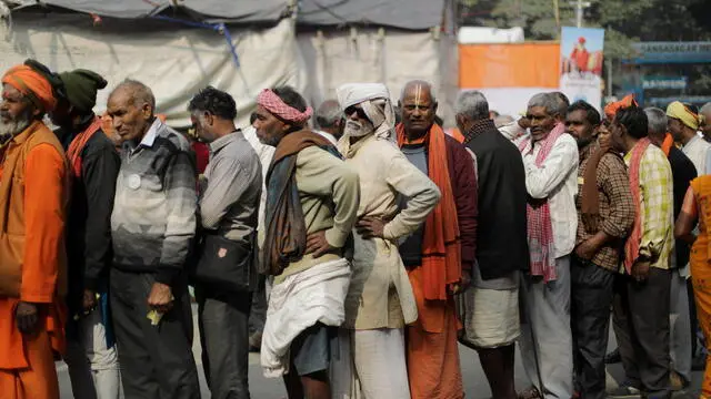 epa11067404 Indian Hindus pilgrims wait in line for a check-up at Babughat transit camp as they head towards Gangasagar Island ahead of Ganga Sagar annual fair in Kolkata, Eastern India 10 January 2024. Ganga Sagar Fair is an annual gathering of Hindu pilgrims during Makar Sankranti at Sagar Island to take a dip in sacred waters of Ganga River before it merges in the Bay of Bengal. EPA/PIYAL ADHIKARY