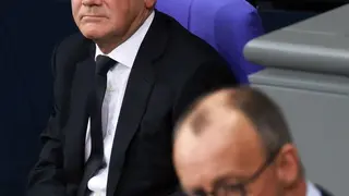 epa11860469 German Chancellor Olaf Scholz (L) looks on as Chairman of the Christian Democratic Union (CDU) party and faction Friedrich Merz speaks during a session of the German parliament 'Bundestag' in Berlin, Germany, 29 January 2025. One of the main topics of session of the Bundestag is the delivery of a government statement by German Chancellor Olaf Scholz on current domestic policy issues. EPA/CLEMENS BILAN