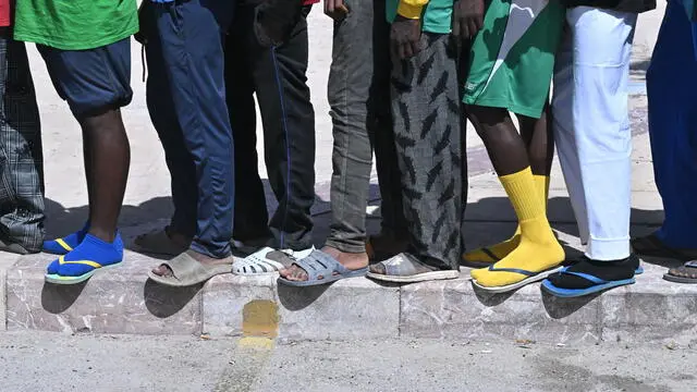 Hundreds of migrants wait in line to be transferred to other places from the island of Lampedusa, southern Italy, 15 September 2023. A record number of migrants and refugees have arrived on the Italian island of Lampedusa in recent days. Lampedusa's city council declared a state of emergency on 13 September evening after a 48-hour continuous influx of migrants. In the morning of September 14, nearly 7,000 migrants were on the island. SIMBOLICA MIGRANTI/SBARCHI/LAMPEDUSA ANSA/CIRO FUSCO