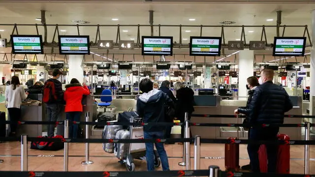 epa09651609 Passenger check in at Brussels Airlines counter as on-board staff of the airline start a 24-hour strike at Brussels Airport in Zaventem, Belgium, 20 December 2021. The on-board staff of Brussels Airlines are on strike to denounce too much pressure at work and the non-respect of several collective labor agreements. Due to the strike, 57 out of 116 flights were canceled, affecting 25 percent of the company's passengers. EPA/STEPHANIE LECOCQ