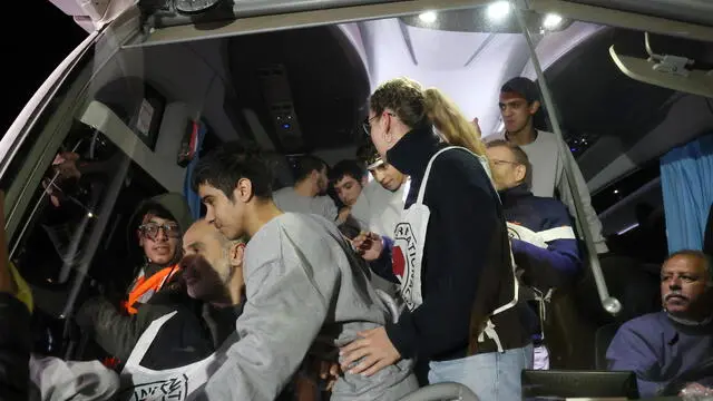 epa10998449 Palestinian prisoners freed from the Ofer Israeli military prison disembark from a bus as they return to Beitonia, near Ramallah, West Bank, 28 November 2023. Israel and Hamas agreed to a four-day ceasefire, mediated by Qatar, the US, and Egypt, that came into effect at 05:00 AM GMT on 24 November. 50 Israeli hostages, women and children are to be released by Hamas and 150 Palestinian women and children that were detained in Israeli prisons are to be released by Israel in exchange. More than 14,000 Palestinians and at least 1,200 Israelis have been killed, according to the Gaza Government media office and the Israel Defense Forces (IDF), since Hamas militants launched an attack against Israel from the Gaza Strip on 07 October, and the Israeli operations in Gaza and the West Bank which followed it. EPA/ALAA BADARNEH