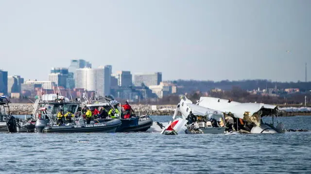 epa11865268 A handout photo made available by the US Coast Guard shows the wreckage of a commercial airplane (R) that collided with an US Army Black Hawk helicopter on Wednesday night in the Potomac River in Washington, DC, USA, 30 January 2025. A PSA Airlines Bombardier CRJ700 regional jet, carrying 64 people, collided in midair on 29 January with a US Army Black Hawk helicopter, carrying three US service members, while on approach to Ronald Reagan National Airport, killing everyone on board both aircraft. EPA/PETTY OFFICER 2ND CLASS TAYLOR BACON / US COAST GUARD HANDOUT HANDOUT EDITORIAL USE ONLY/NO SALES