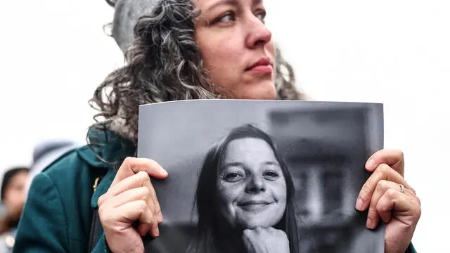 epa10436334 A protester holding a picture of Cecile Kohler, who has been detained in Iran since 07 May 2022, at a rally in support of French detainees in Iran, organized by support committees and families, at Place du Trocadero near the Eiffel Tower in Paris, France, 28 January 2023. Seven French nationals are imprisoned in Iran, accused of espionage by the Iranian authorities. EPA/Mohammed Badra