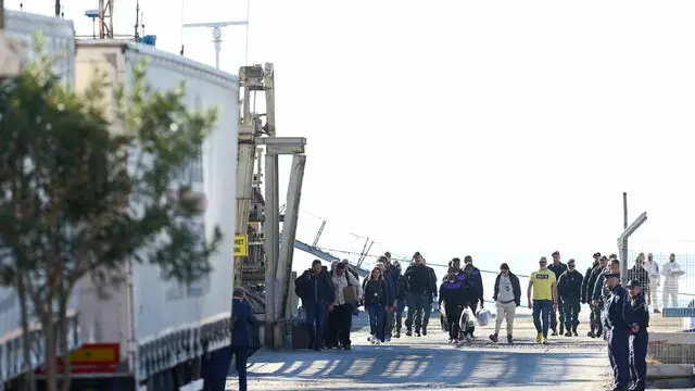 epa11709511 A group of migrants (C) intercepted in international waters around Italy, disembark the Italian Navy vessel Libra at Shengjin, Albania, 08 November 2024. Italy has sent a group of 8 migrants to Albania, after a previous group was turned away in October for failing the vetting process, in a plan aimed at deterring dangerous sea crossings by processing asylum claims outside the EU. The initiative faced legal setbacks after Italian courts ruled that migrants could not be held in Albania due to concerns over their legal status. In response, the Italian government adjusted the legal framework, hoping this would strengthen the policy, which allows up to 3,000 non-vulnerable men to be housed temporarily in Italian-run facilities in Albania. EPA/MALTON DIBRA