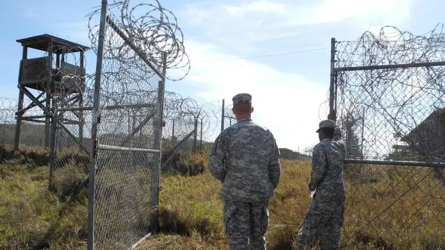 epa03836451 US Sergeants Cody Stagner (L) and Lerone Simmons on the grounds of the now closed Camp X-Ray in Guantanamo Bay, Cuba, 22 August 2013. The Guantanamo Bay detention camp is a controversial United States military prison located within Guantanamo Bay Naval Base, Cuba that was established in January 2002. EPA/Johannes Schmitt-Tegge No data!