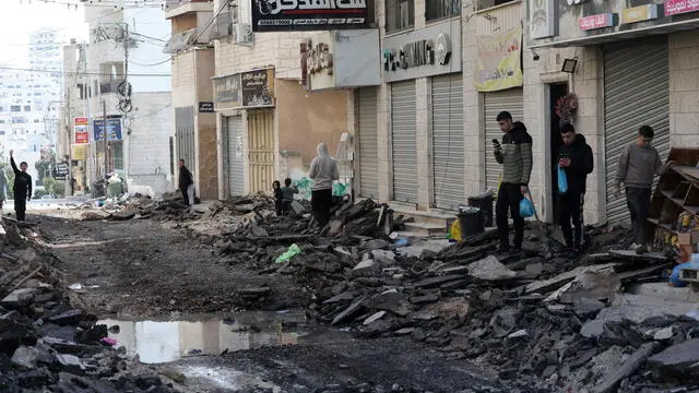 epa11857918 Palestinians inspect the damage on the second day of an Israeli military raid at Tulkarem refugee camp, near the West Bank city of Tulkarem, 28 January 2025. At least two Palestinians were killed and a dozen injured in the Israeli military raid in Tulkarem and its camp, according to the Palestinian Ministry of Health. EPA/ALAA BADARNEH