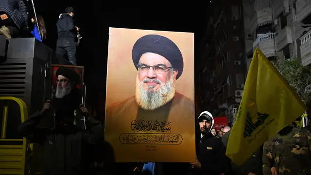 epa11750190 People hold photos of late Hezbollah leader Hassan Nasrallah during a commemoration event organized by the group at the site where Nasrallah was killed, Haret Hreik neighborhood in southern Beirut, Lebanon, 30 November 2024. Nasrallah was killed in an Israeli strike on Beirut on 27 September. A 60-day ceasefire agreement between Israel and Hezbollah came into force on 27 November. EPA/STRINGER