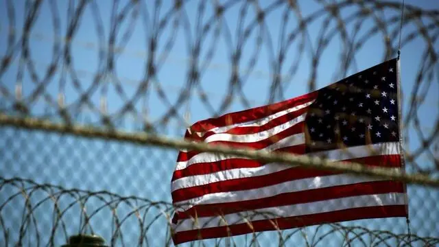 epa05177019 (FILE) A file picture dated 14 September 2005 shows a US flag at Delta Camp 5 on the United States Naval Station in Guantanamo Bay, Cuba. US President Barack Obama on 23 February 2016 presented his plans to close the Guantanamo Bay detention centre in Cuba. Obama announced to close the facility when he took office in 2009, but his efforts have been hindered by Congress. The facility, located on a US naval base on the island, has housed terrorist suspects since shortly after the September 11, 2001 terrorist attacks, and Congress has blocked efforts to bring any detainees to the United States. EPA/MIKE BROWN