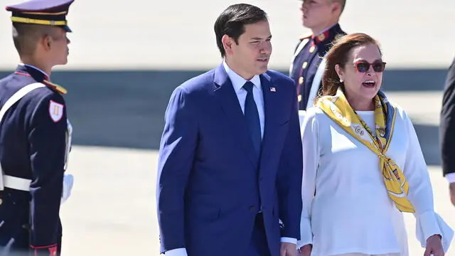 epa11873342 US Secretary of State Marco Rubio (C) speaks with Salvadoran Minister of Foreign Affairs Alexandra Hill Tinoco (R) upon his arrival at Oscar Arnulfo Romero International Airport in San Luis Talpa, in El Salvador, 03 February 2025. Rubio will meet El Salvador's President Bukele while he tours Latin American countries to talk about migration to the U.S. southern border. EPA/STRINGER