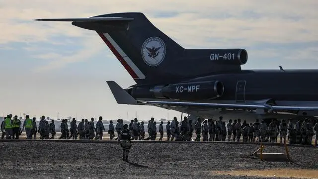 Mexican National Guard members disembark at Abraham Gonzalez International Airport in Ciudad Juarez, Chihuahua state, Mexico on February 4, 2025. Mexico began the 10,000-strong border troop deployment it had promised US President Donald Trump in exchange for delaying a 25-percent tariff on exported goods, President Claudia Sheinbaum said. (Photo by Herika Martinez / AFP)