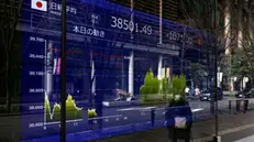 epa11871831 A passerby walks past a stock market indicator board in Tokyo, Japan, 03 February 2025. Tokyo stocks plunged losing more than two percent following concerns on the impact on global economy of US President Trump's decision on tariffs for China, Mexico and Canada. EPA/FRANCK ROBICHON