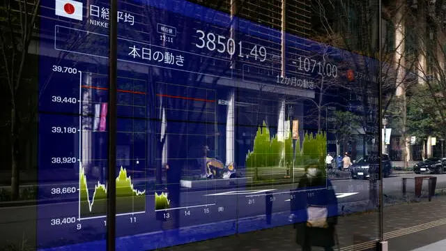 epa11871831 A passerby walks past a stock market indicator board in Tokyo, Japan, 03 February 2025. Tokyo stocks plunged losing more than two percent following concerns on the impact on global economy of US President Trump's decision on tariffs for China, Mexico and Canada. EPA/FRANCK ROBICHON