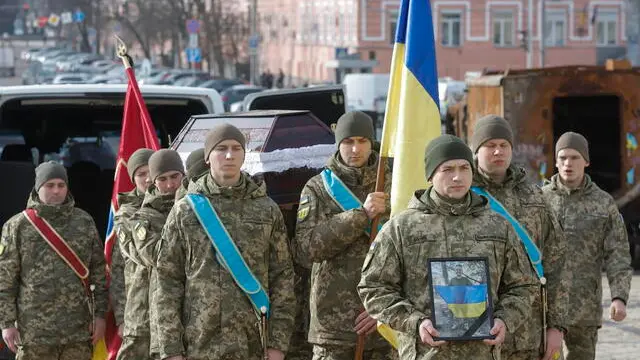 epa11863729 Relatives, friends and comrades of late Polish national Filip Antosiak attend his farewell ceremony at St. Mykhailivsky Cathedral in Kyiv, 30 January 2025. Polish volunteer Filip Antosiak, 19, fought for Ukraine in the 25th Separate Airborne Brigade and was killed in action on 19 January near Pokrovsk, Donetsk. EPA/SERGEY DOLZHENKO