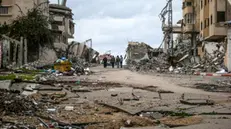 epa11880881 Palestinians walk between destroyed bulidings in Tal Alhawa neighbourhood amid a ceasefire between Israel and Hamas, in Gaza City, Gaza Strip, 07 February 2025. Israel and Hamas implemented the first phase of a hostage release and ceasefire deal on 19 January 2025. More than 46,000 Palestinians have been killed in the Gaza Strip, according to the Palestinian Ministry of Health, since Israel launched a military campaign in the strip in response to a cross-border attack led by the Palestinian militant group Hamas on 07 October 2023, in which about 1,200 Israelis were killed and more than 250 taken hostage. EPA/MOHAMMED SABER