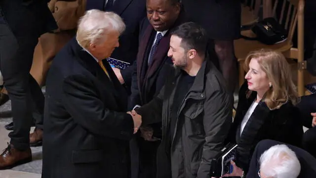 epa11762990 US President-elect Donald Trump (L) shakes hands with Ukrainian President Volodymyr Zelensky (C) inside the Notre Dame de Paris cathedral, ahead of its official reopening ceremony, in Paris, France, 07 December 2024. The Notre Dame de Paris Cathedral reopens on 07 December after nearly six years of renovation work following its destruction by a fire on 15 April 2019. EPA/LUDOVIC MARIN / POOL MAXPPP OUT
