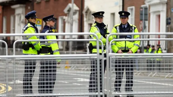 epa02734611 A group of police stand behind barriers erected to restrict access to the Garden of Remembrance in Dublin 15 May 2011 ahead of the historic visit by Britain's Queen Elizabeth II. The four day visit begins on 17 May amid a huge security operation. The Garden of Remembrance will be visited by the Queen during her stay. EPA/Enda Doran