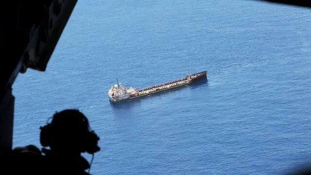 epa02222865 US Coast Guard Petty Officer Everett Hill views an oil tanker at the site of the BP Deepwater Horizon oil well spill site in the Gulf of Mexico off the coast of Louisiana, USA 25 June 2010, during a US Coast Guard overflight. The BP Deepwater Horizon oil spill, which began over two months ago, is the largest in US history and continues to threaten wildlife, the ecosystem and the economy of the Gulf Coast as BP and government officials attempt to stop the flow and remove what has already been released. EPA/ERIK S. LESSER