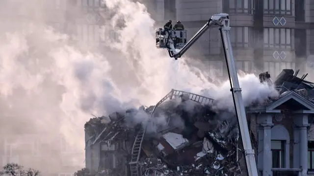 epa11800927 Rescuers work at the site of a drone attack on a residential building in Kyiv, Ukraine, 01 January 2025, amid the ongoing Russian invasion. According to the State Emergency Service, at least three people were injured as a result of a Russian drone attack on Kyiv. Russian troops entered Ukraine on 24 February 2022, starting a conflict that has provoked destruction and a humanitarian crisis. EPA/YAN DODRONOSOV