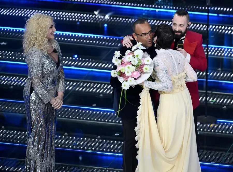 Sanremo Festival host and artistic director Carlo Conti (C) and co-hosts and Italian presenters Antonella Clerici (L) with Italian duo Coma Cose on stage at the Ariston theatre during the 75th edition of the Sanremo Italian Song Festival, in Sanremo, Italy, 11 February 2025. The music festival will run from 11 to 15 February 2025. ANSA/ETTORE FERRARI