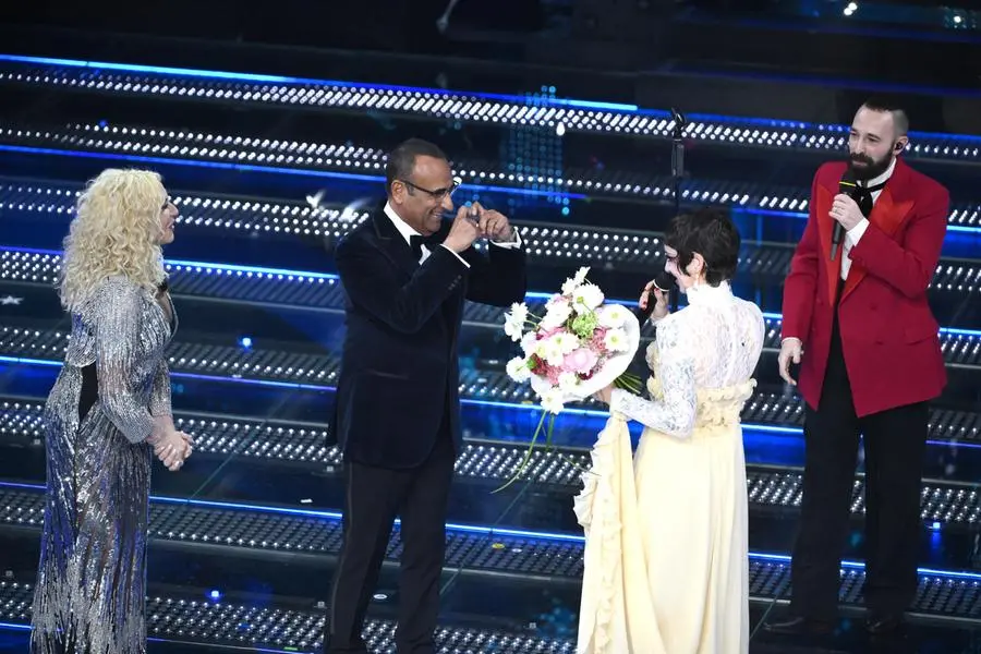 Sanremo Festival host and artistic director Carlo Conti (C) and co-hosts and Italian presenters Antonella Clerici (L) with Italian duo Coma Cose on stage at the Ariston theatre during the 75th edition of the Sanremo Italian Song Festival, in Sanremo, Italy, 11 February 2025. The music festival will run from 11 to 15 February 2025. ANSA/ETTORE FERRARI