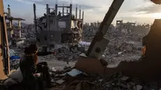 epaselect epa11888850 Palestinian youth watch the sunset from their destroyed house in the Jabalia camp, north of Gaza City, 11 February 2025. Israel and Hamas implemented the first phase of a hostage release and ceasefire deal on 19 January 2025. More than 48,000 Palestinians have been killed in the Gaza Strip, according to the Palestinian Ministry of Health, since Israel launched a military campaign in the strip in response to a cross-border attack led by the Palestinian militant group Hamas on 07 October 2023, in which about 1,200 Israelis were killed and more than 250 taken hostage. EPA/HAITHAM IMAD