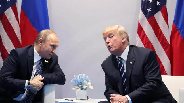 epa06073287 Russian President Vladimir Putin (L) and US President Donald J. Trump (R) meet on the sidelines of the G20 summit in Hamburg, Germany, 07 July 2017. The G20 Summit (or G-20 or Group of Twenty) is an international forum for governments from 20 major economies. The summit is taking place in Hamburg from 07 to 08 July 2017. EPA/MICHAEL KLIMENTYEV / SPUTNIK / KREMLIN POOL / POOL MANDATORY CREDIT