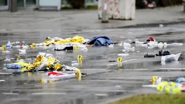 epa11893041 Yellow signs placed by forensics experts at the scene where a vehicle was driven into a Ver.di demonstration in Munich, Germany, 13 February 2025. According to statements from Munich police, at least 28 people were injured, two of them seriously. The driver of the vehicle involved in the incident, a 24-year-old Afghan asylum seeker, has been arrested, police added. EPA/RONALD WITTEK