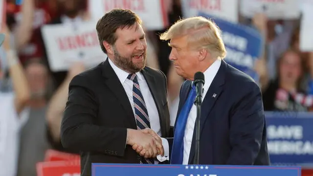 epa09905603 Former US President Donald Trump (R) gives his endorsement to Republican Ohio US Senate candidate J.D. Vance (L) during a Save America rally at the Delaware County Fairgrounds in Delaware, Ohio, USA, 23 April 2022. EPA/DAVID MAXWELL
