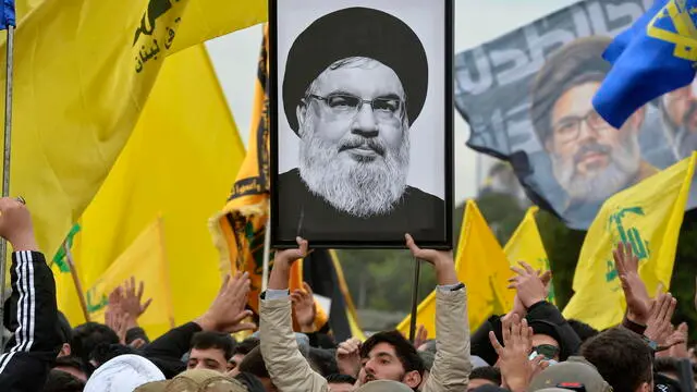 epa11898892 Supporters of Hezbollah shout slogans as they carry flags of Hezbollah and a photo of Hezbollah late leader Hassan Nasrallah during a protest in front of the entrance to Rafic Hariri International Airport in Beirut, Lebanon, 15 February 2025. Hezbollah supporters attempted to block the main road to Beirut's Rafic Hariri International Airport for the third consecutive day in protest of the decision to deny an Iranian plane permission to land at the airport. EPA/WAEL HAMZEH