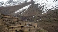 epa06587288 Hoses of Tighanimin village are surrounded by snow-covered mountains, near Azilal city, central Morocco, 05 March 2018 (issued 07 March 2018). Azilal is a city in central Morocco, in the Atlas Mountains, that had over 27,000 Moroccans living according to 2004 census. Temperatures usually drop far below zero during the Winter, and snow fall cuts the twisty roads connecting the remote villages to the center of Azilal city. Villagers share rides in small bus or on the back of truck, or simply walk on foot, as children make their way to school or villagers visit the souk (market). However, vehicles can be stuck in snow for hours and drivers seen praying to make a safe journey on the risky roads. Women collect firewood in the morning to be used as source of heating and for cooking. EPA/BAKIR MOHAMMED ATTENTION: This Image is part of a PHOTO SET