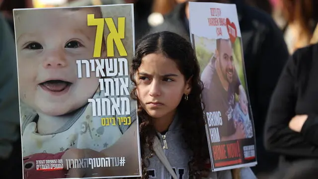epa11867338 People watching a live stream report on a big screen on the release of three Israeli hostages, Keith Siegel, Ofer Calderon and Yarden Bibas transferred from Hamas to the Red Cross, in hostages square outside the Kirya military base in Tel Aviv, Israel, 01 February 2025. Hostages Keith Siegel, Ofer Calderon and Yarden Bibas were abducted from their homes in the Kibbutz near the Israeli Gaza border during the Hamas led October 7th attack. According to the Israeli army, around 80 hostages are still being held by Hamas in Gaza. EPA/ABIR SULTAN