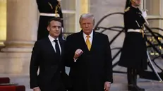 epa11762345 French President Emmanuel Macron (L) welcomes US president-elect Donald J. Trump at Elysee Palace prior the reopening ceremony of the Notre Dame de Paris Cathedral, in Paris, France, 07 December 2024. The Notre-Dame de Paris Cathedral reopens on 07 December after nearly six years of renovation work following its destruction by a fire on 15 April 2019. EPA/MOHAMMED BADRA